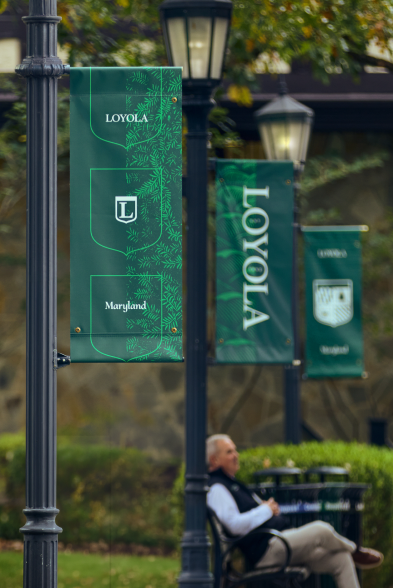 Loyola Maryland brand banners displayed along a campus walkway