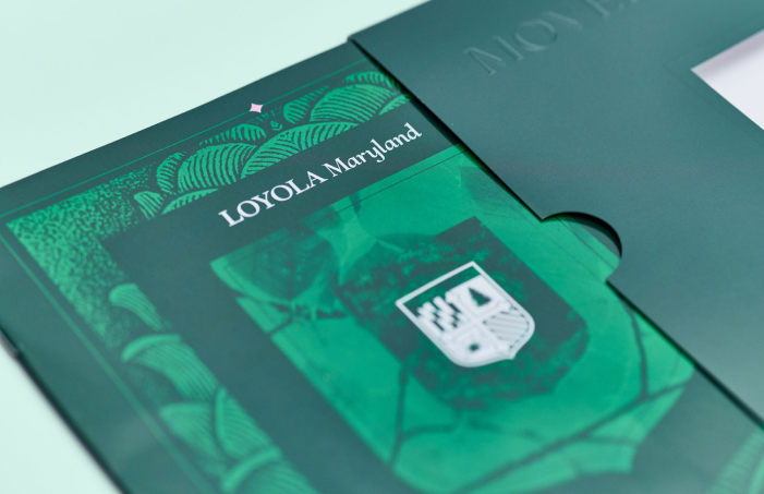 Loyola Maryland prospective student viewbook and green presentation sleeve